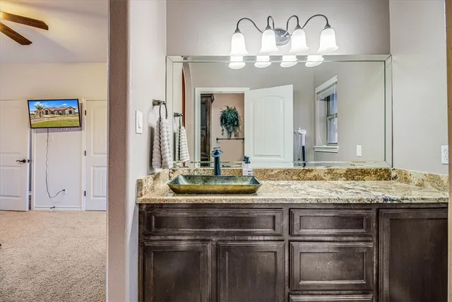 a bedroom with a bed and a ceiling fan
