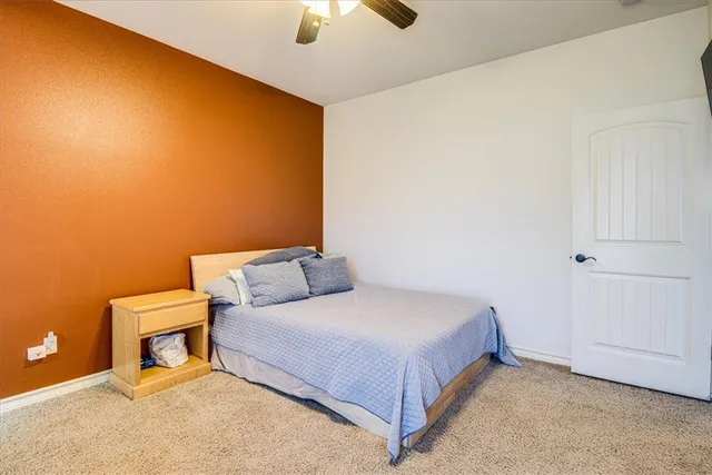 a spacious bedroom with a bed and a window