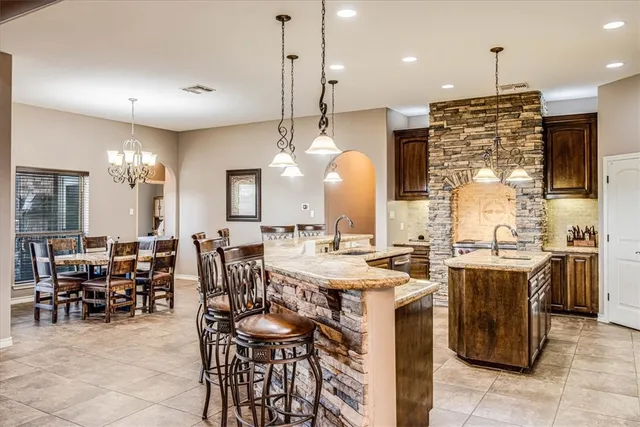 a large kitchen with a large counter top appliances and living room