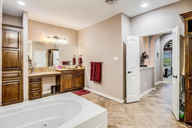 a kitchen with stainless steel appliances a stove top oven a sink and a refrigerator