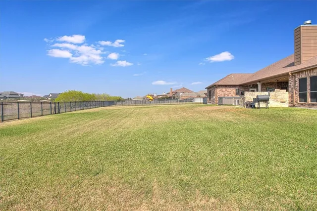 a front view of house with yard and trees
