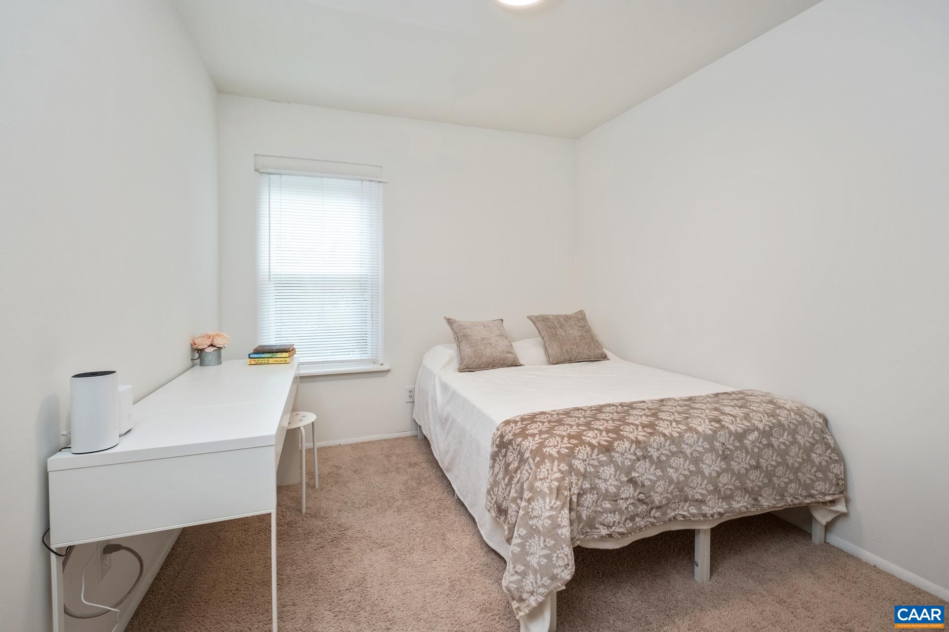 407 Valley Rd Extension, Unit A Charlottesville, VA 22903 - Photo 13 of 24 a bedroom with a bed and a table