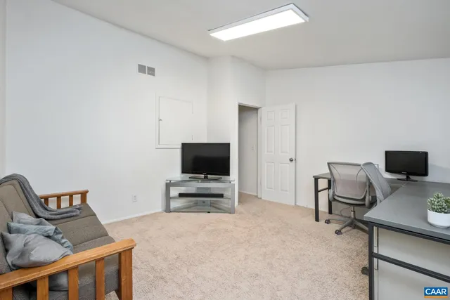 a livingroom with a flat screen tv and a couch