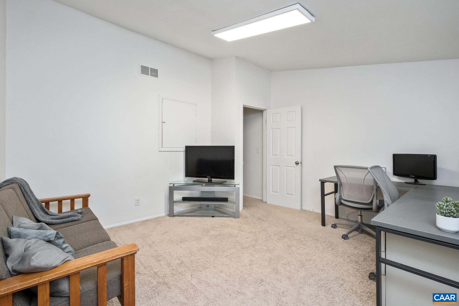 407 Valley Rd Extension, Unit A Charlottesville, VA 22903 - Photo 15 of 24 a livingroom with a flat screen tv and a couch