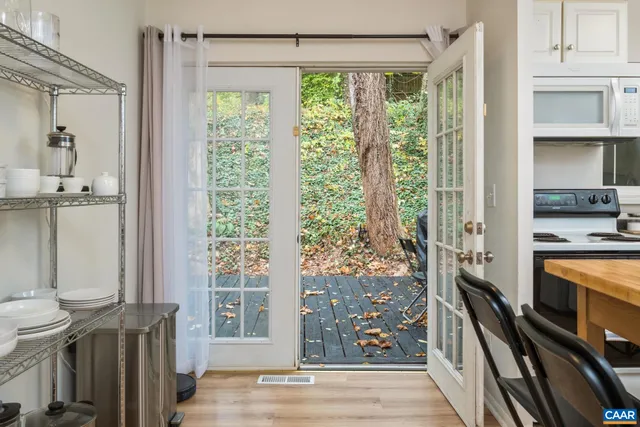 a view of an entryway with wooden floor and windows