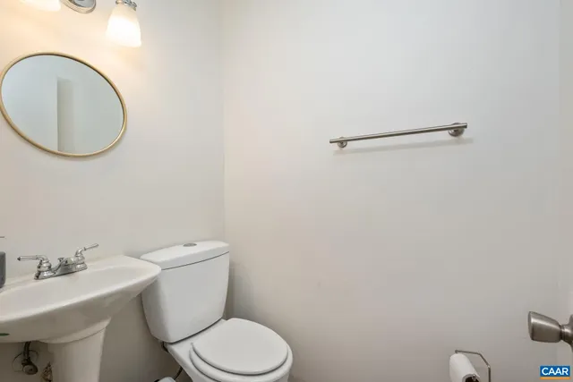 a white toilet sitting next to a bathroom sink