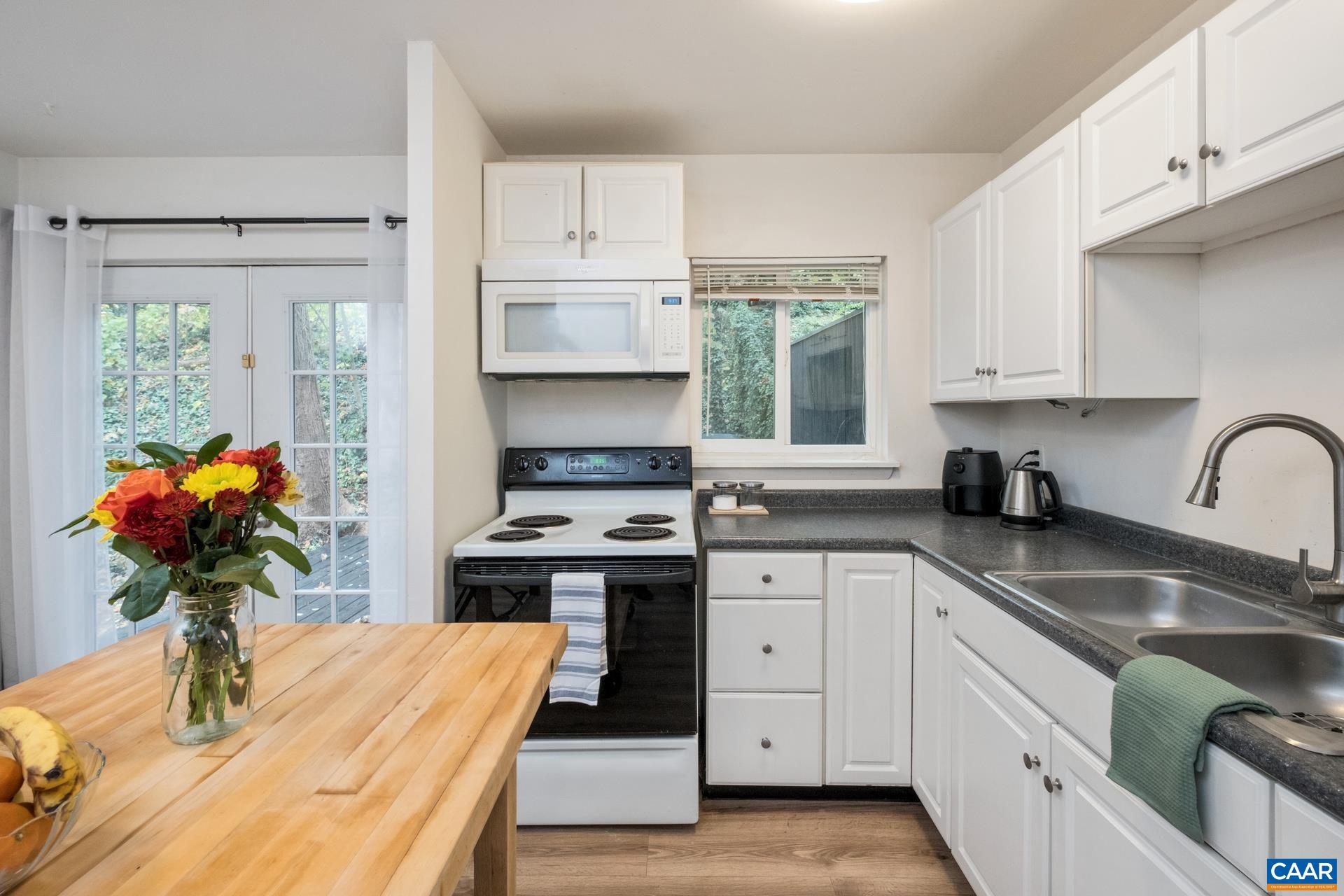 407 Valley Rd Extension, Unit A Charlottesville, VA 22903 - Photo 8 of 24 a kitchen with stainless steel appliances a sink dishwasher stove refrigerator and cabinets