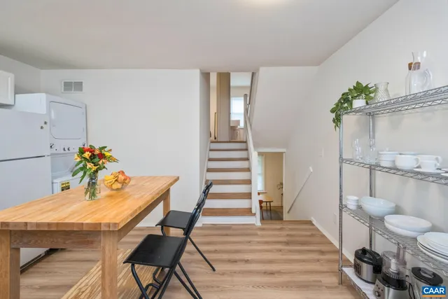 a view of a dining room with furniture and wooden floor
