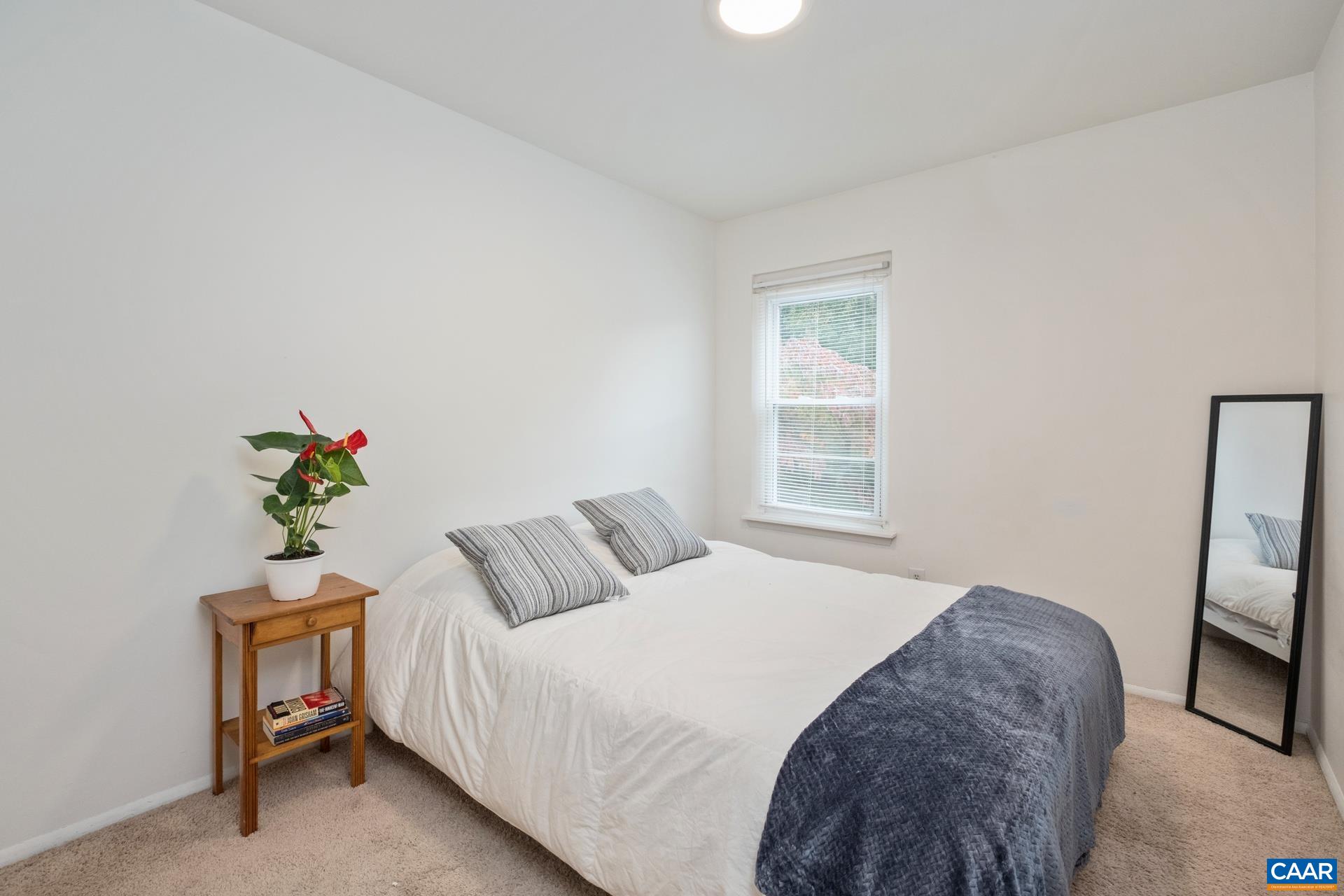 407 Valley Rd Extension, Unit A Charlottesville, VA 22903 - Photo 10 of 24 a bedroom with a bed and a window