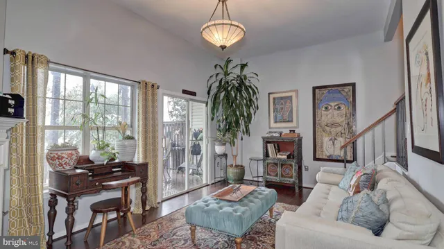 a living room with furniture a chandelier and a window