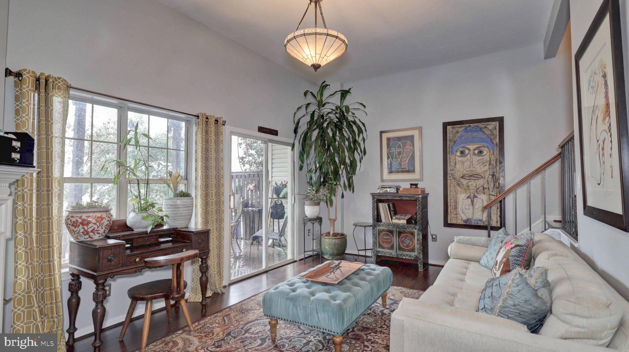 44072 Florence Terrace Ashburn, VA 20147 - Photo 12 of 31 a living room with furniture a chandelier and a window