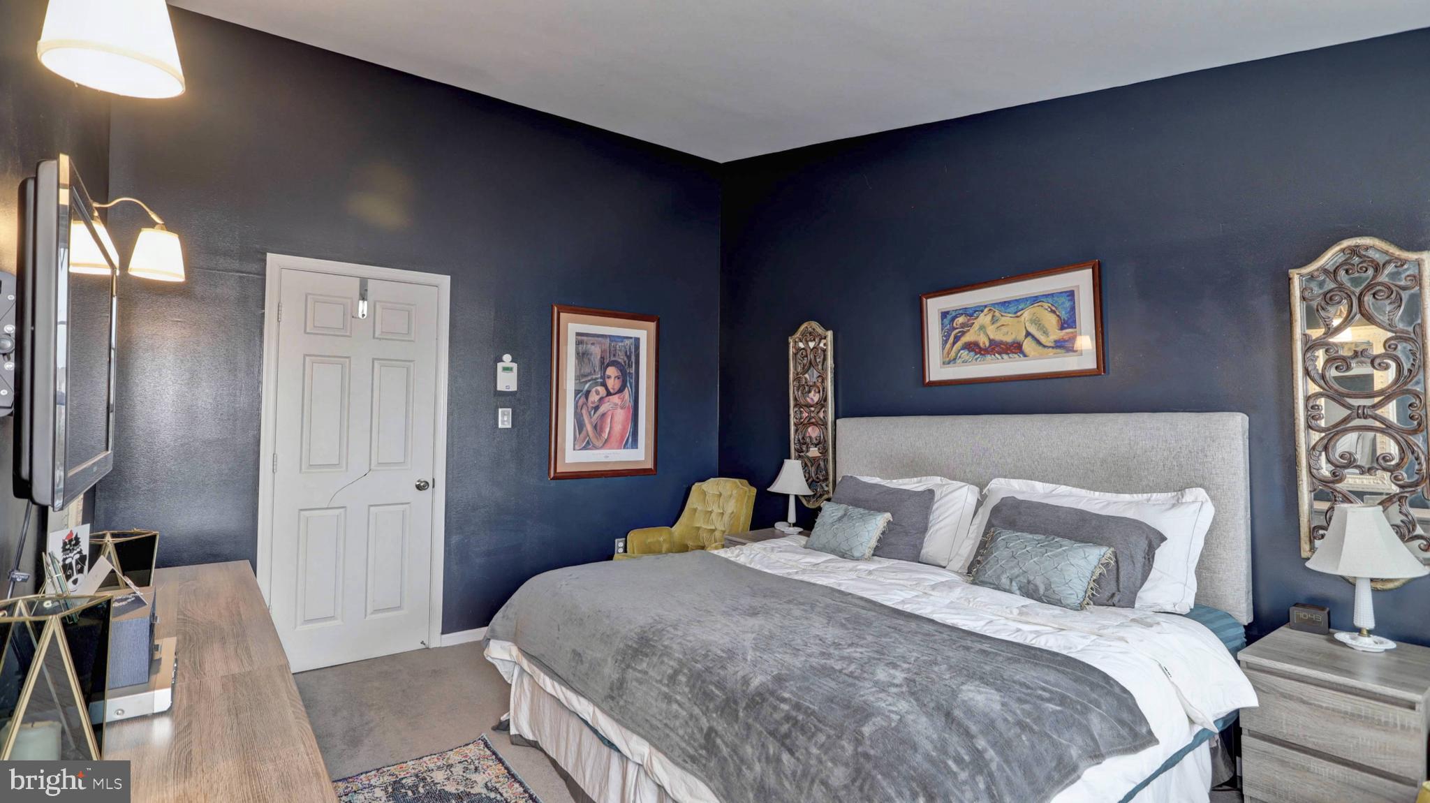 44072 Florence Terrace Ashburn, VA 20147 - Photo 16 of 31 a bedroom with a bed and a painting on the wall