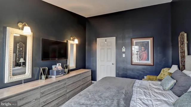 a bedroom with furniture and a flat screen tv