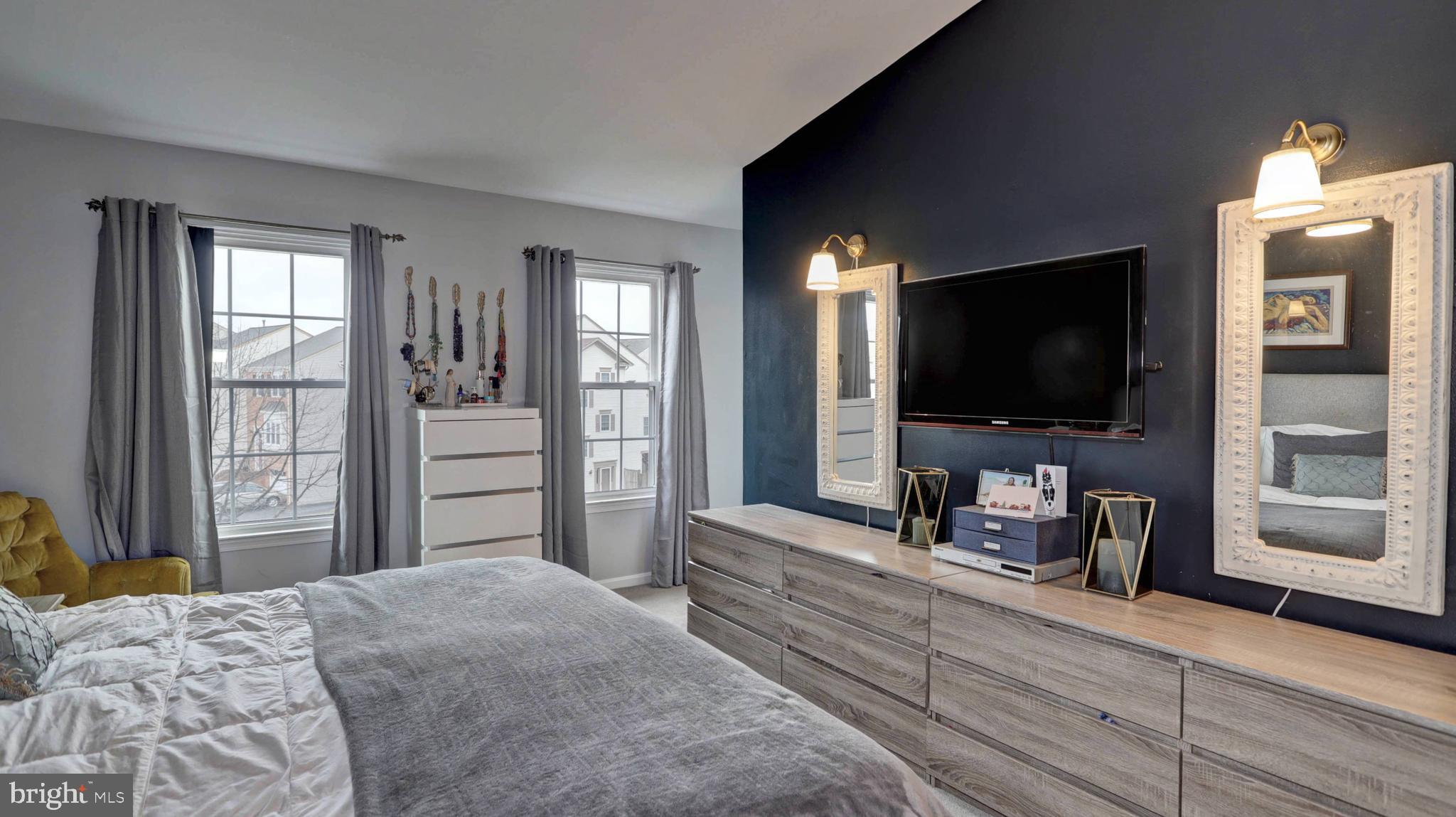 44072 Florence Terrace Ashburn, VA 20147 - Photo 18 of 31 a bedroom with a bed and a flat screen tv