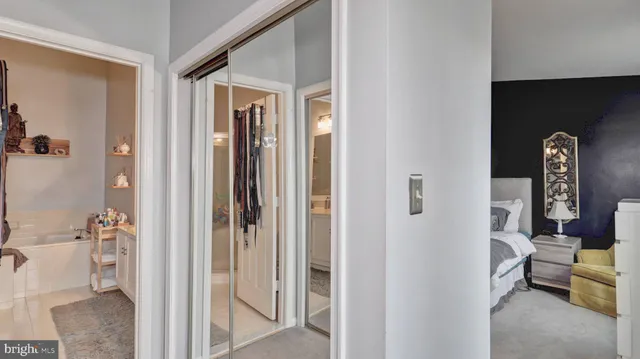 a view of a hallway with bathroom and glass door