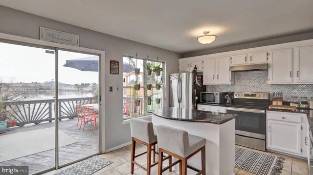 a kitchen with a table chairs refrigerator and cabinets