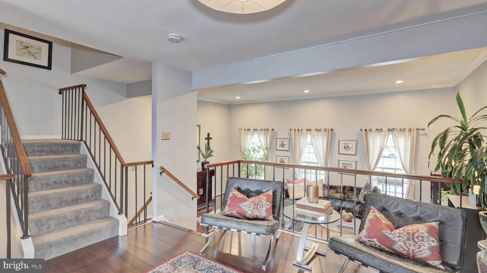 44072 Florence Terrace Ashburn, VA 20147 - Photo 9 of 31 a living room with furniture stairs and a wooden floor