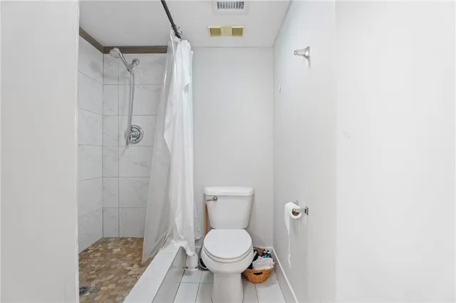 a white toilet sitting next to a bathroom sink