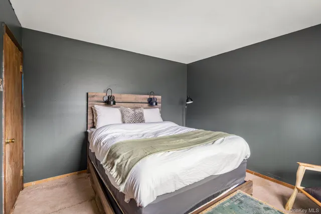 a bedroom with a bed and a chair