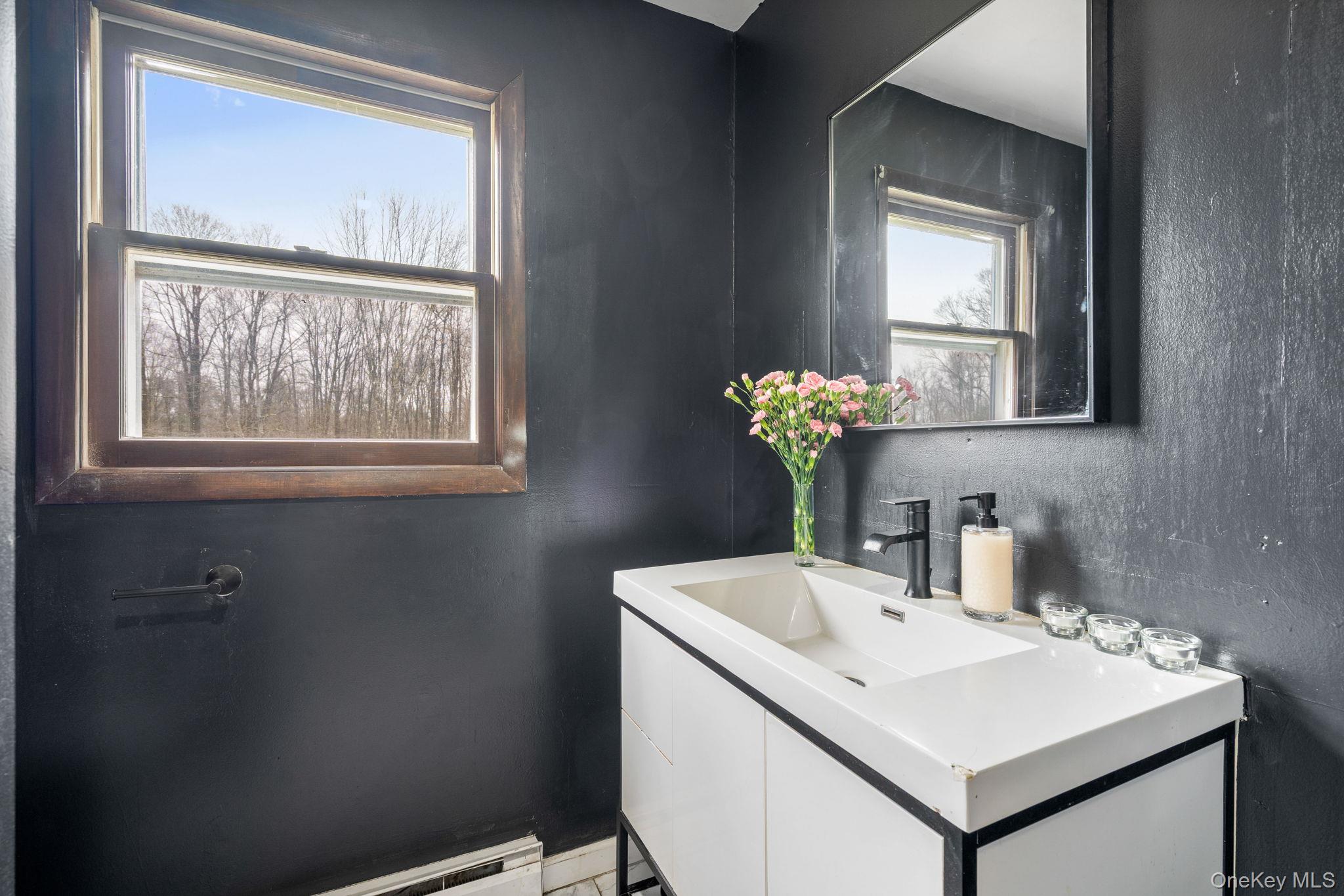 178 Bowers Road Loch Sheldrake, NY 12759 - Photo 19 of 47 a bathroom with a sink and a mirror