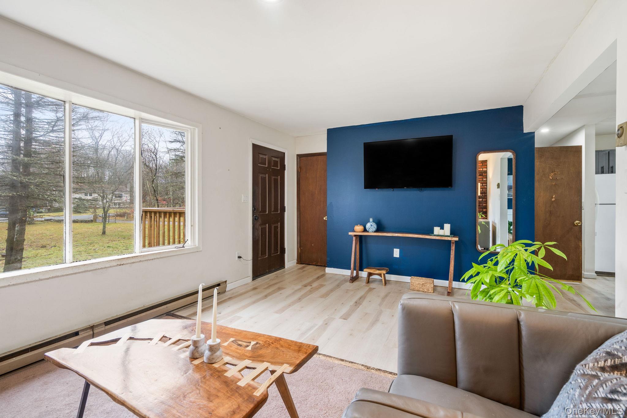 178 Bowers Road Loch Sheldrake, NY 12759 - Photo 4 of 47 a living room with furniture and a flat screen tv