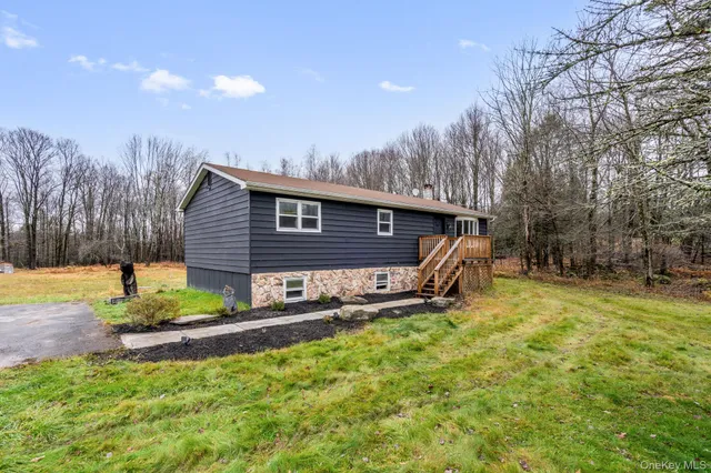 a view of a house with a big yard and potted plants