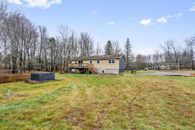 a view of a house with a yard and wooden fence