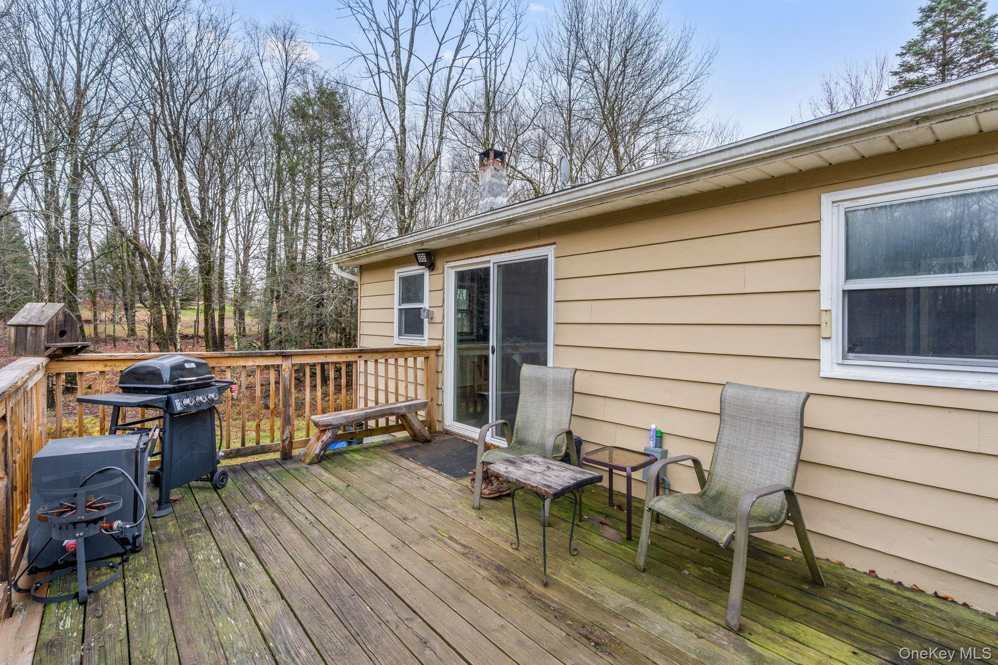 178 Bowers Road Loch Sheldrake, NY 12759 - Photo 47 of 47 a view of a patio with table and chairs and wooden floor