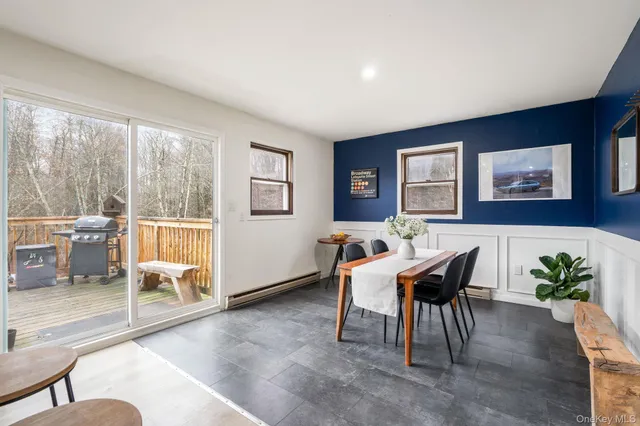 a workspace with furniture and a large window