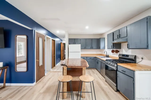 a kitchen with a table chairs refrigerator and cabinets
