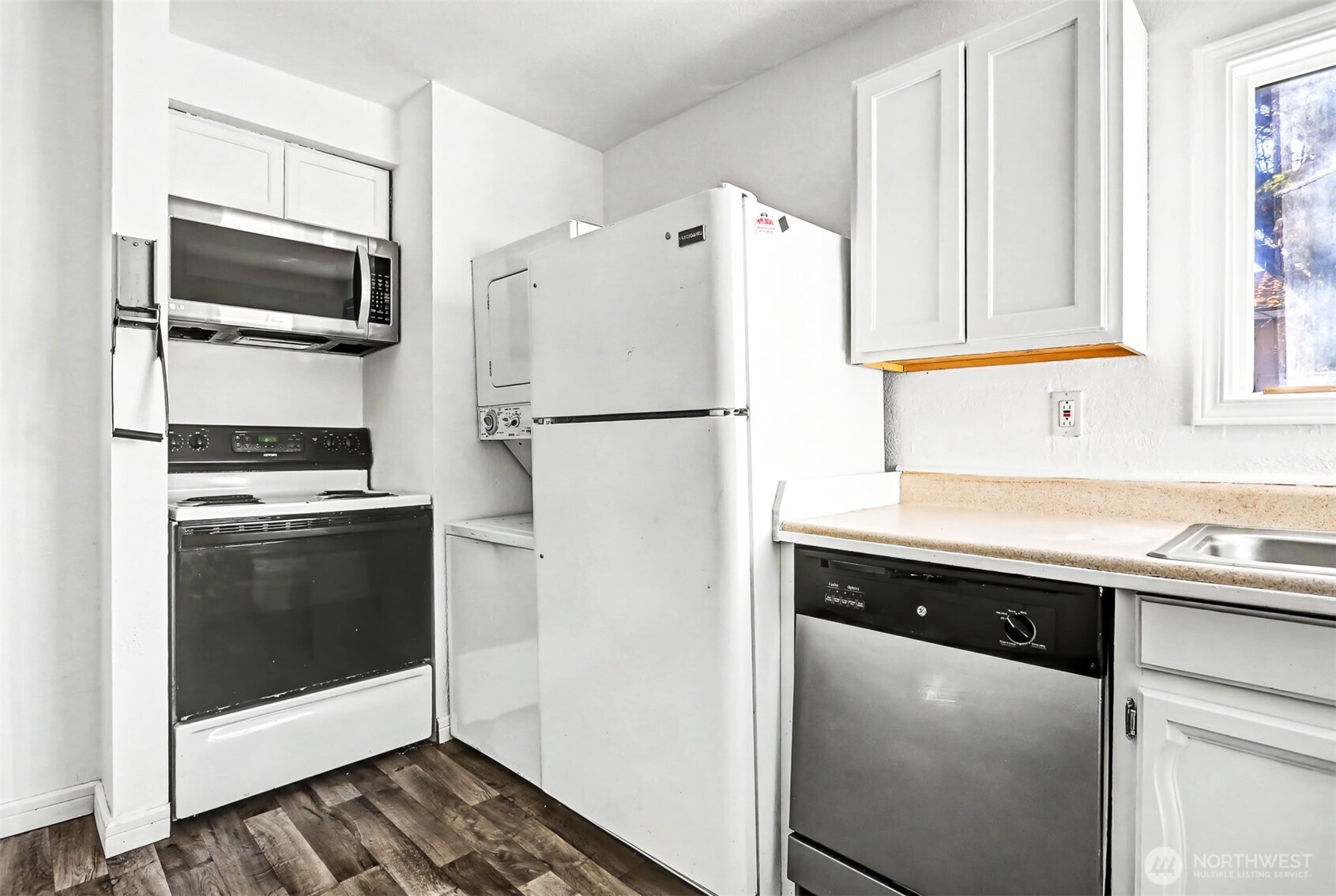 1328 Chestnut Street Everett, WA 98201 - Photo 9 of 24 a white refrigerator freezer and a stove sitting inside of a kitchen with granite countertop a refrigerator and a sink