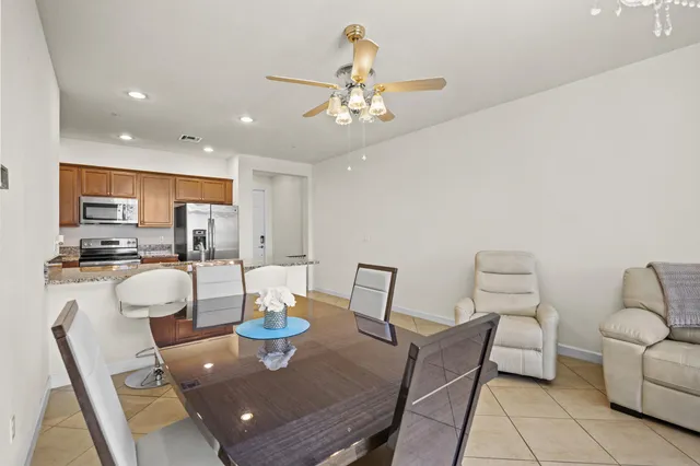 a living room with furniture and kitchen view