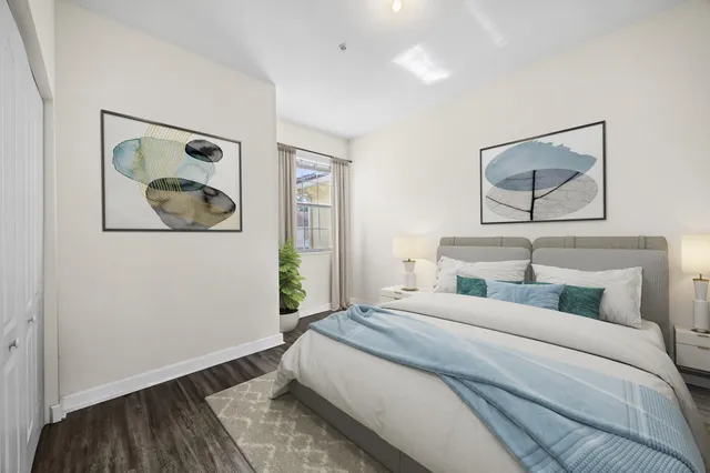 a bedroom with a bed and a painting on the wall