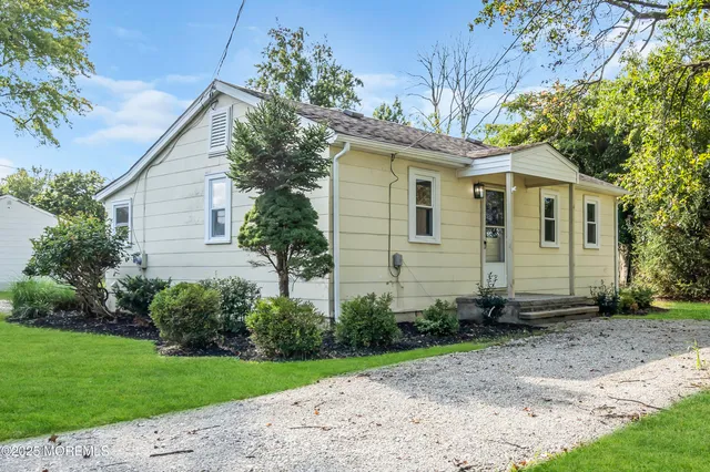 a view of a backyard with a garden and entertaining space
