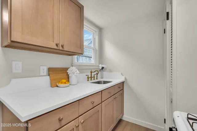 a living room with furniture kitchen view and a window