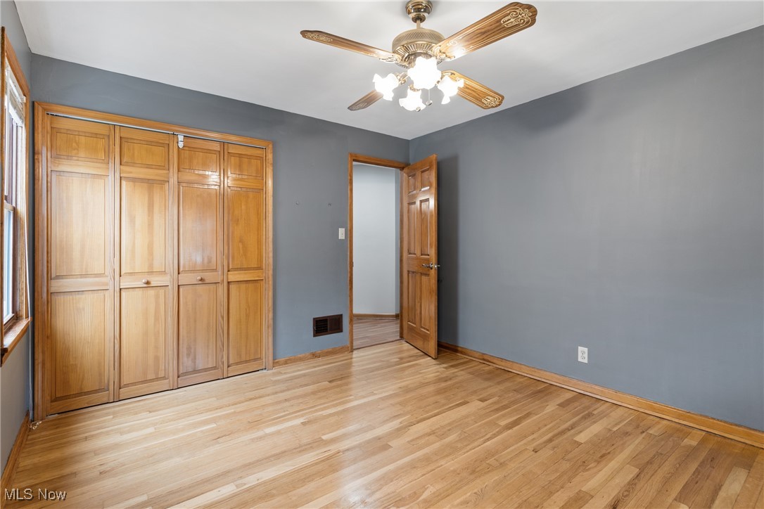 7514 Spring Garden Road Cleveland, OH 44129 - Photo 16 of 30 Main floor bedroom featuring light wood finished floors, healthy amount of natural light, and ceiling fan