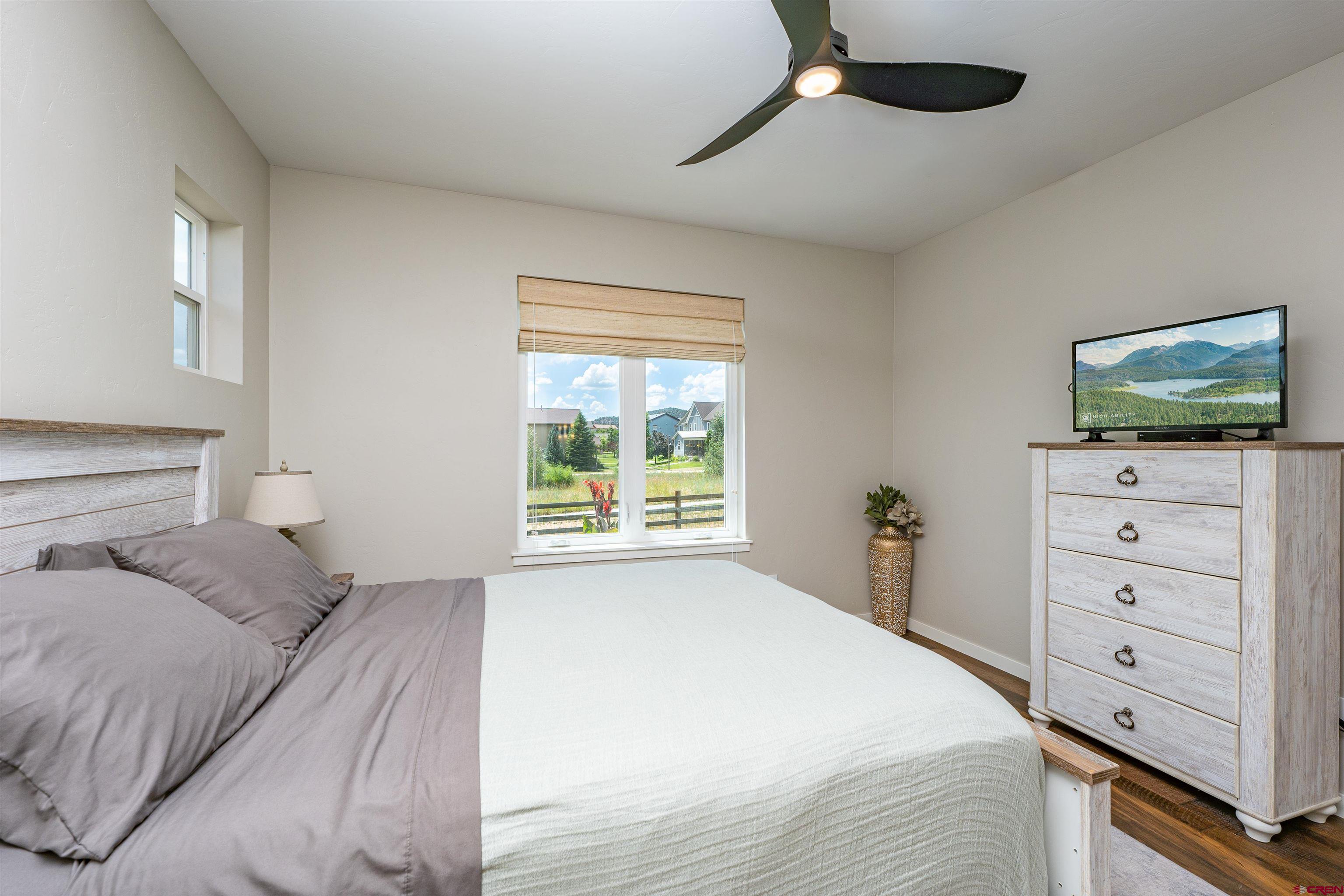 74 Prospector Avenue Durango, CO 81301 - Photo 12 of 30 a bedroom with a bed and a flat screen tv
