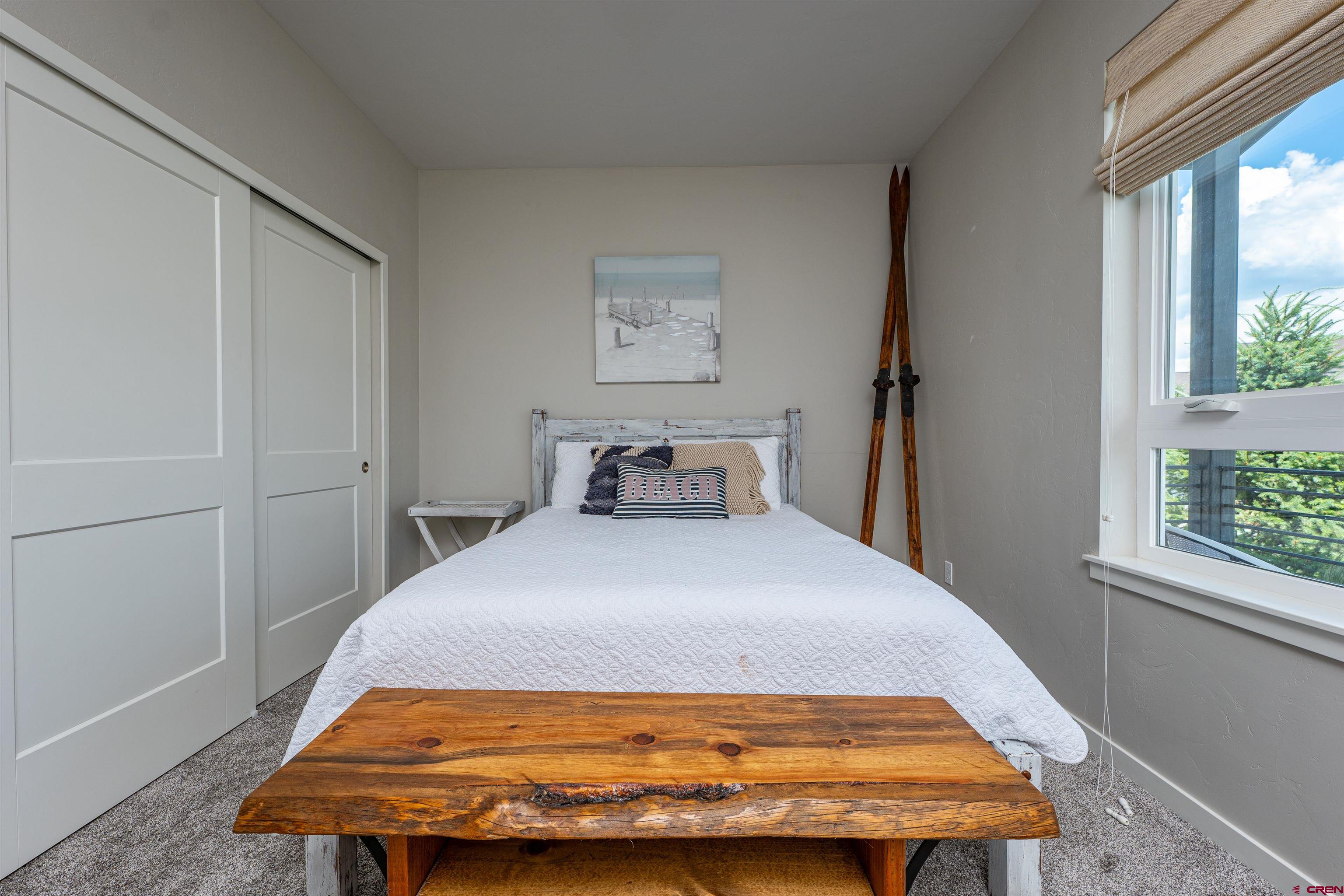 74 Prospector Avenue Durango, CO 81301 - Photo 16 of 30 a bedroom with a bed and wooden floor