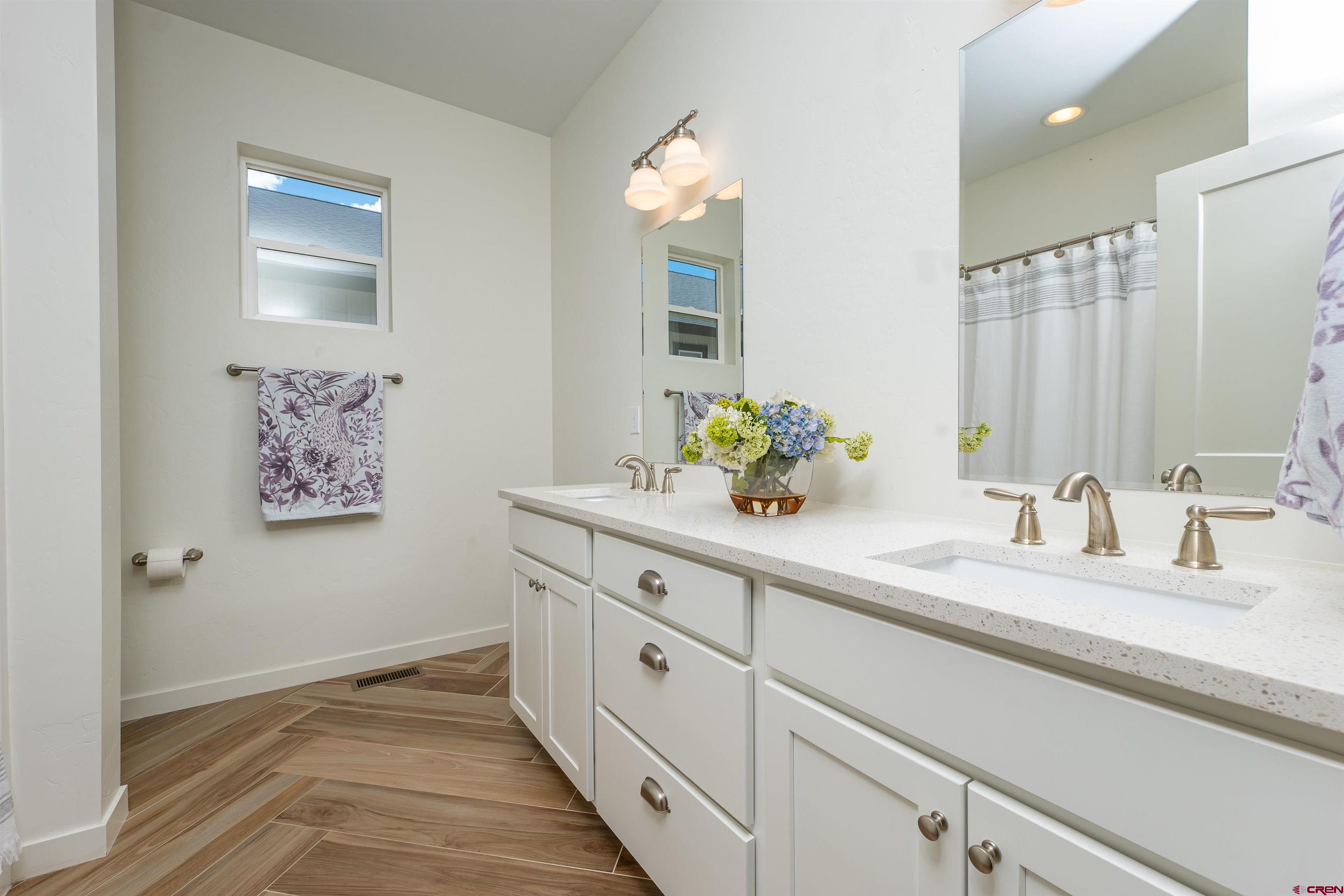 74 Prospector Avenue Durango, CO 81301 - Photo 22 of 30 a spacious bathroom with double vanity sink and a mirror