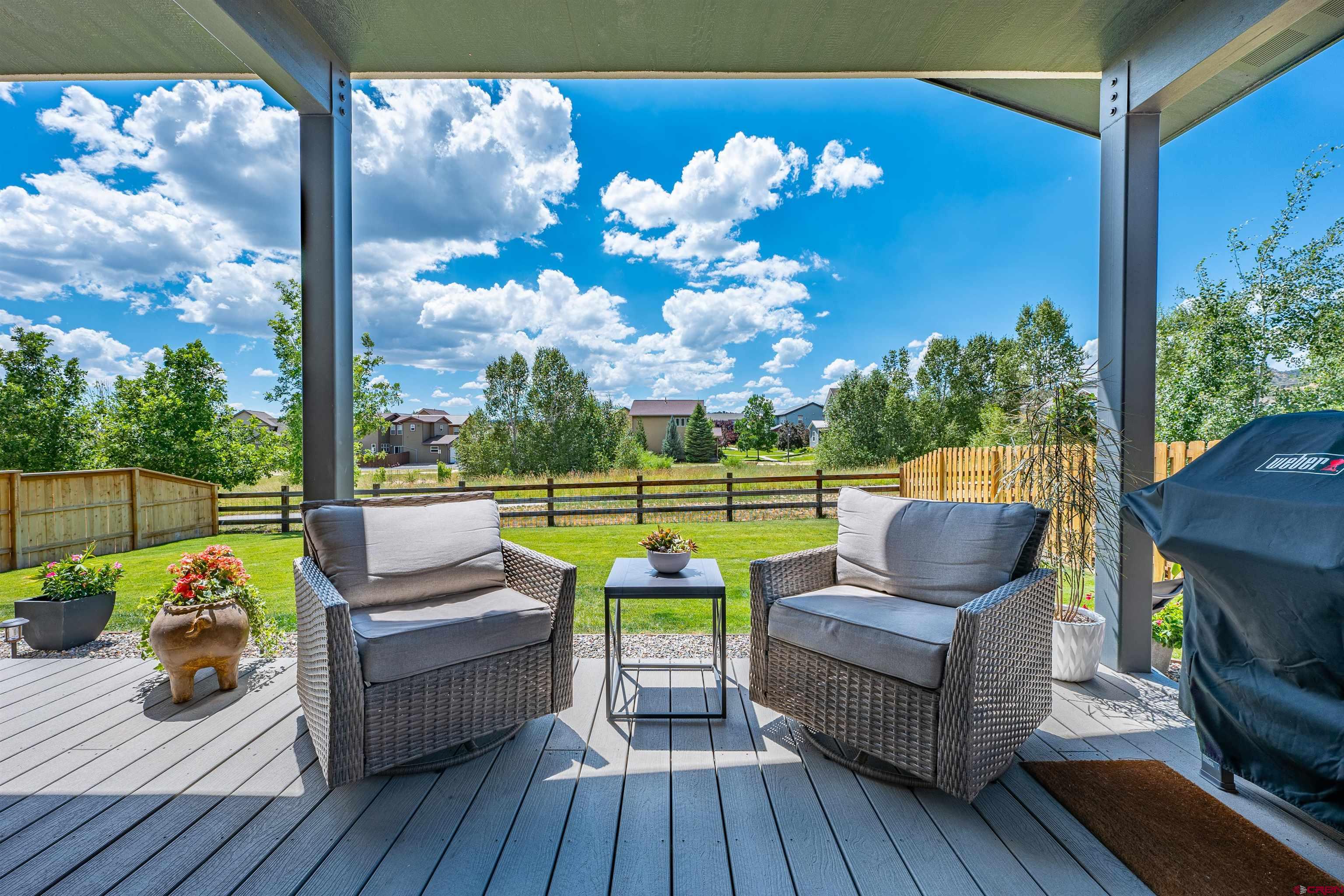 74 Prospector Avenue Durango, CO 81301 - Photo 25 of 30 a view of a patio with couches chairs and a floor to ceiling window with wooden floor