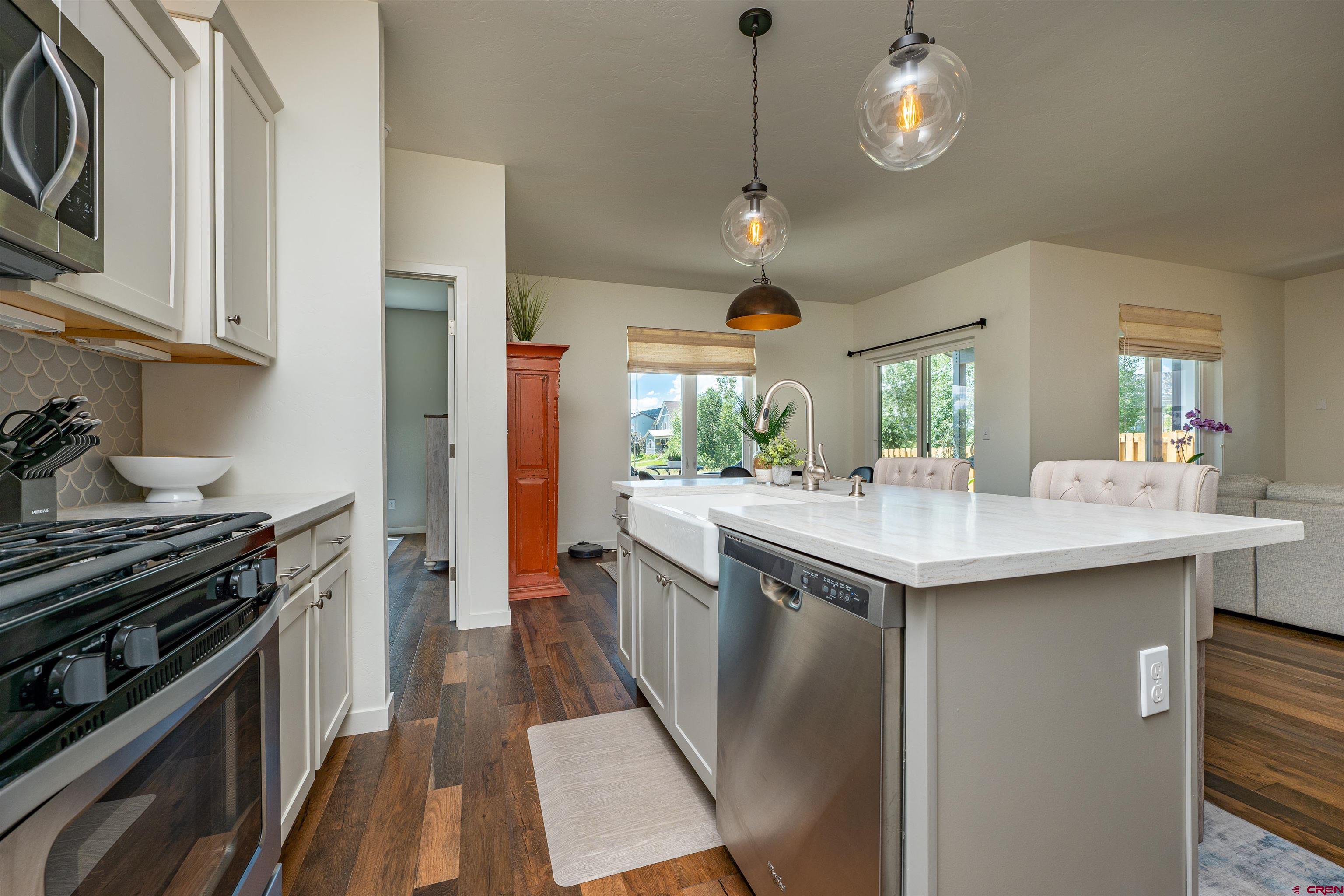 74 Prospector Avenue Durango, CO 81301 - Photo 8 of 30 a kitchen with stainless steel appliances granite countertop a sink and a stove