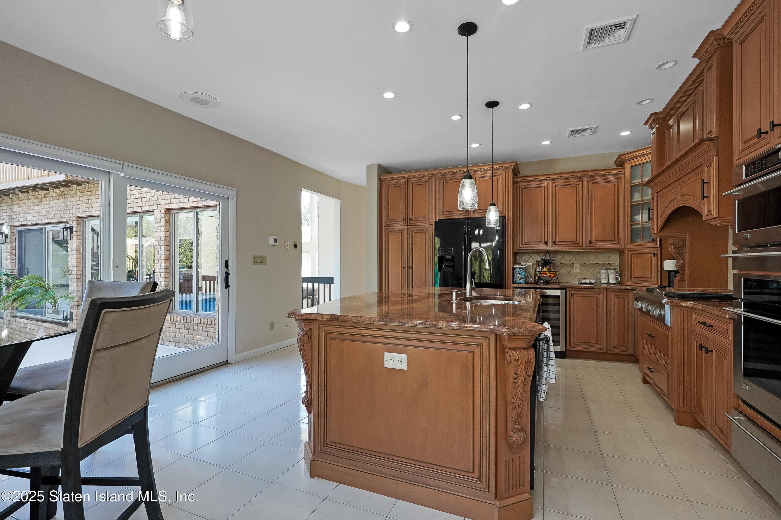 Undisclosed Address Staten Island, NY 10307 - Photo 15 of 72 a view of a kitchen with kitchen island stainless steel appliances wooden floor dining table and chairs