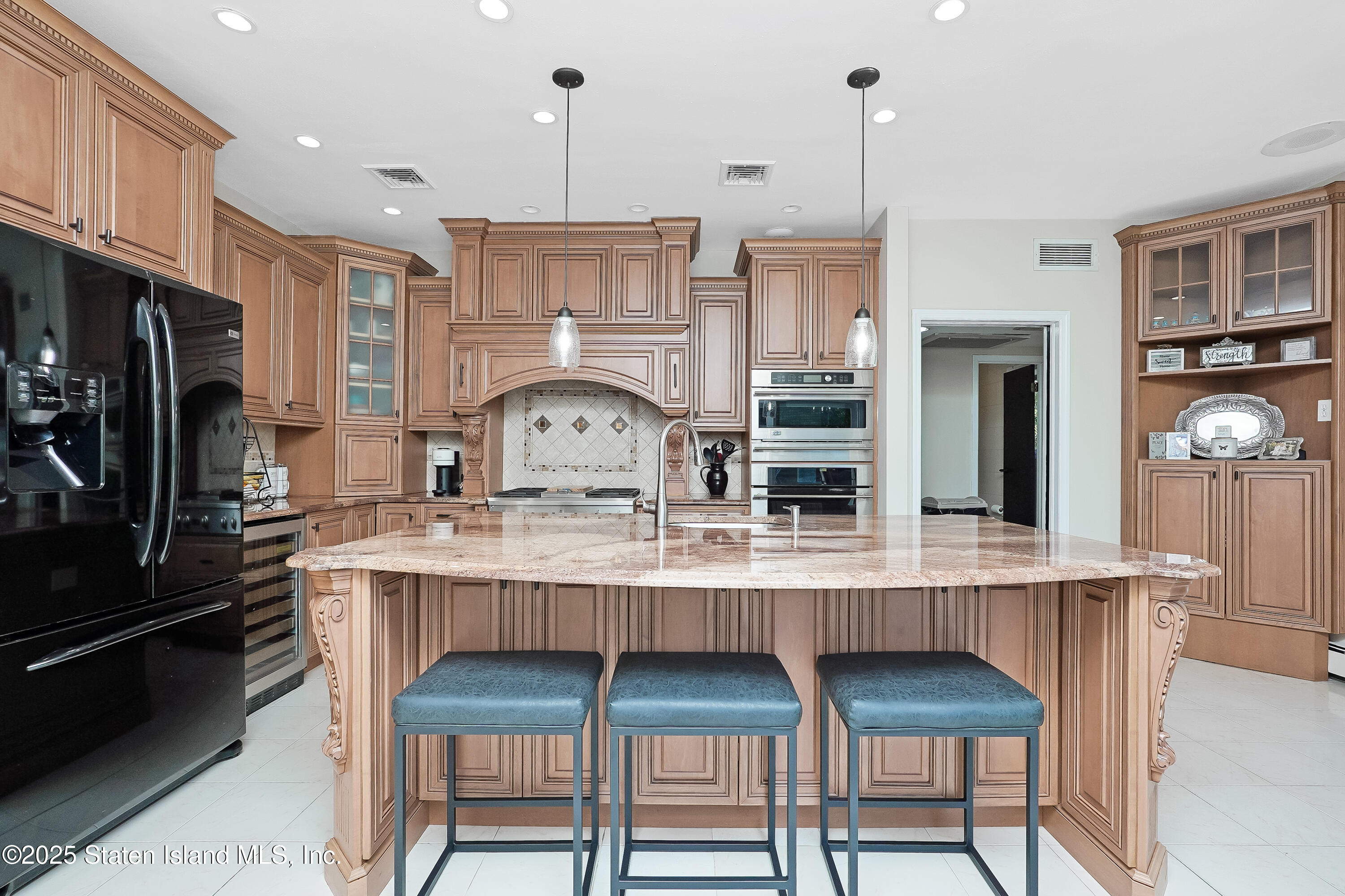Undisclosed Address Staten Island, NY 10307 - Photo 18 of 72 a kitchen with granite countertop a table chairs stove refrigerator and cabinets