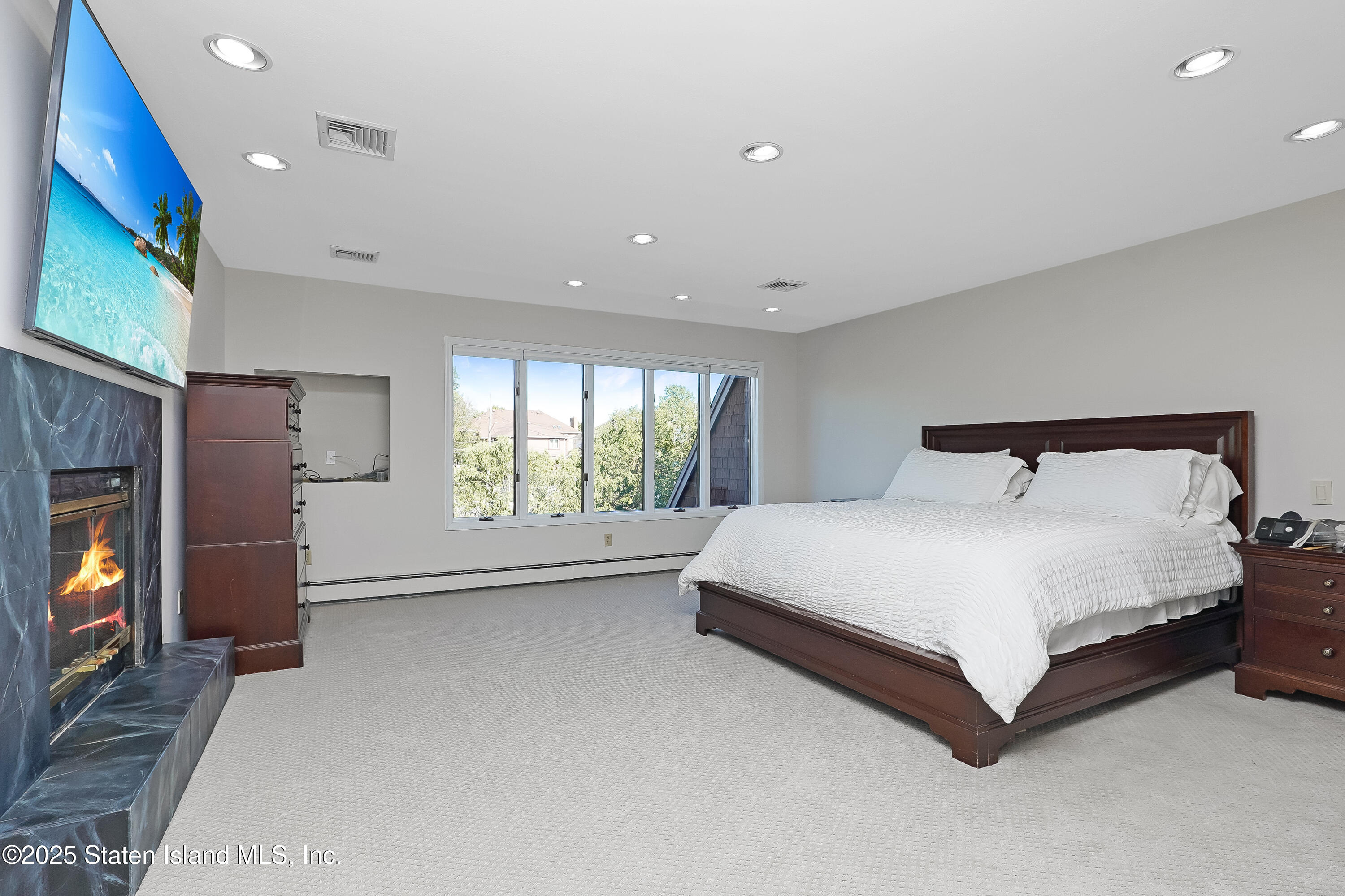 Undisclosed Address Staten Island, NY 10307 - Photo 33 of 72 a large bed sitting in a room next to a window