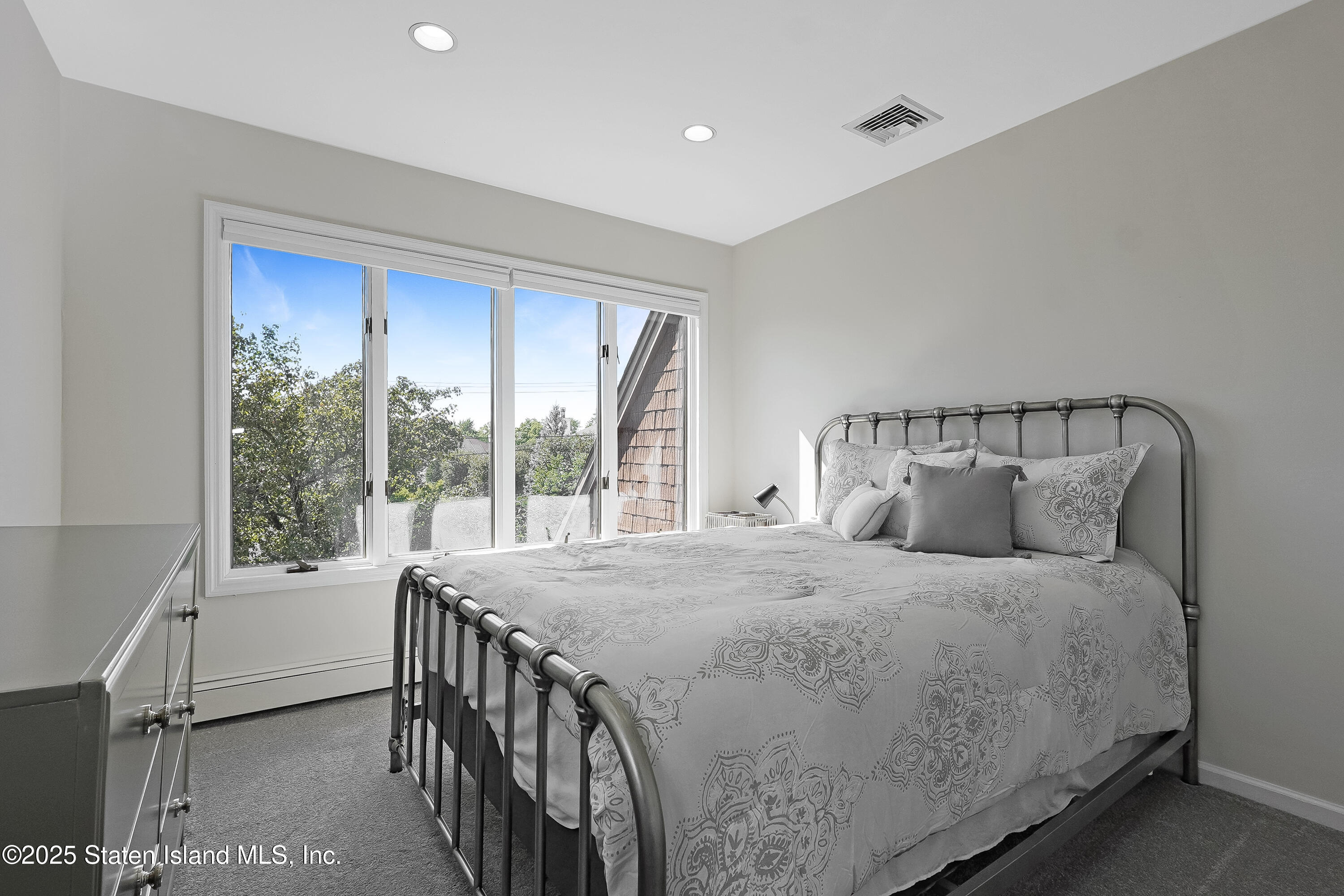 Undisclosed Address Staten Island, NY 10307 - Photo 44 of 72 a bedroom with a bed and a large window