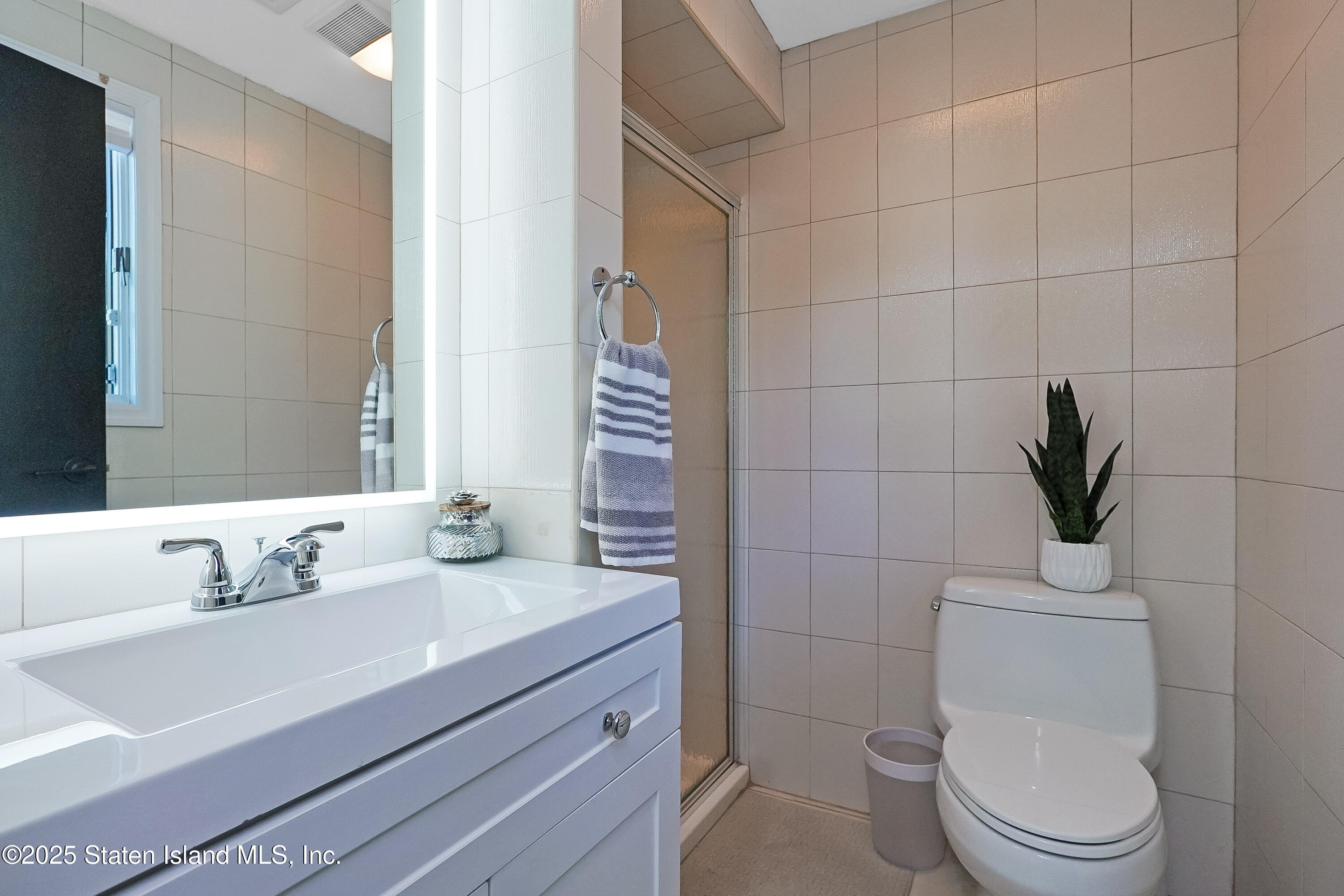 Undisclosed Address Staten Island, NY 10307 - Photo 46 of 72 a bathroom with a sink a toilet and vanity