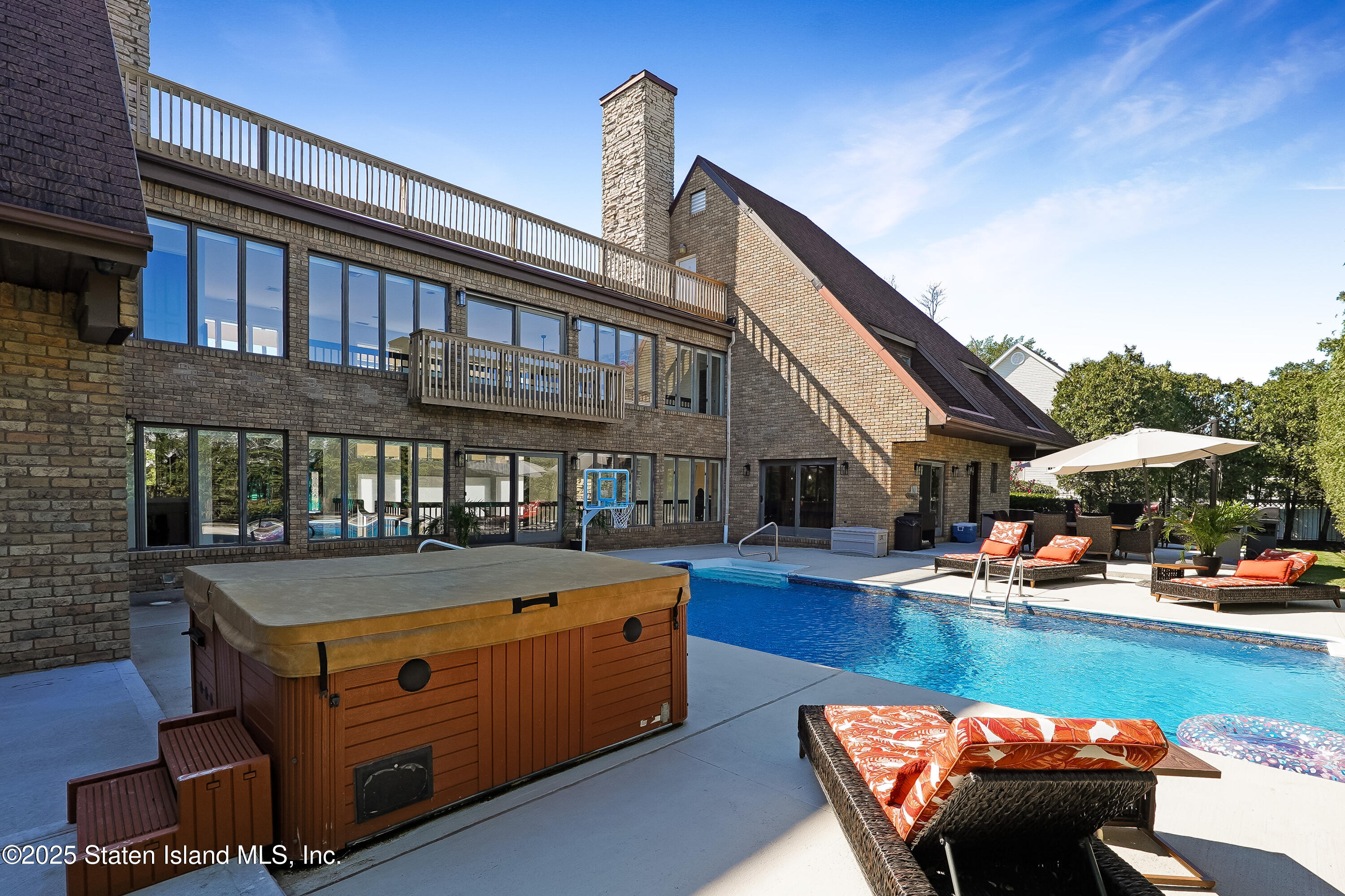 Undisclosed Address Staten Island, NY 10307 - Photo 51 of 72 a view of a swimming pool with couches and lounge chairs