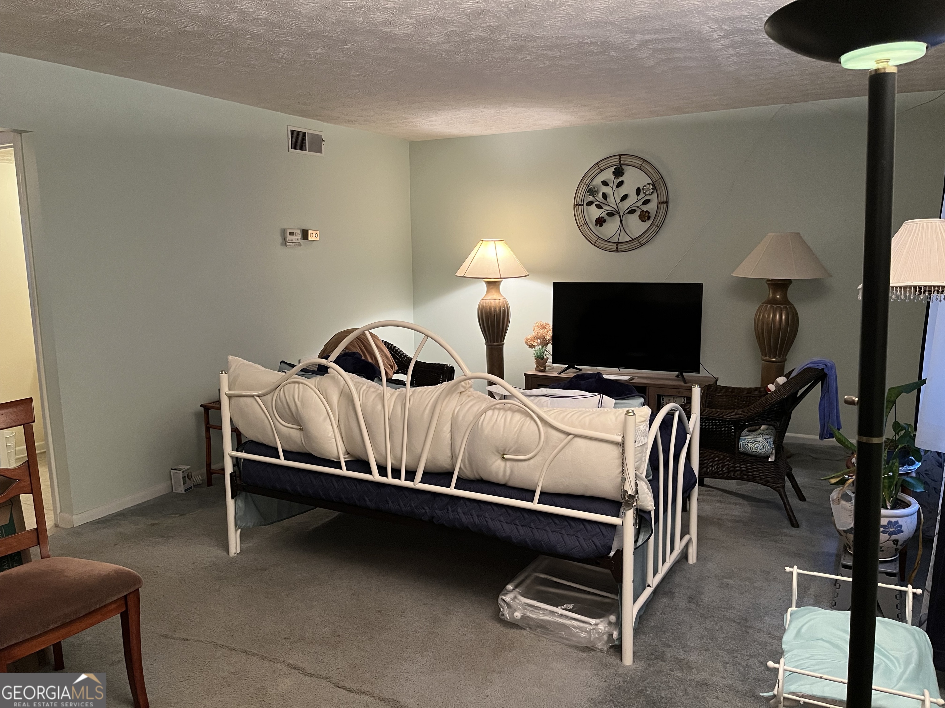 501 Carlton Road, Unit 4C Palmetto, GA 30268 - Photo 4 of 12 a bedroom with a bed and a lamp on table