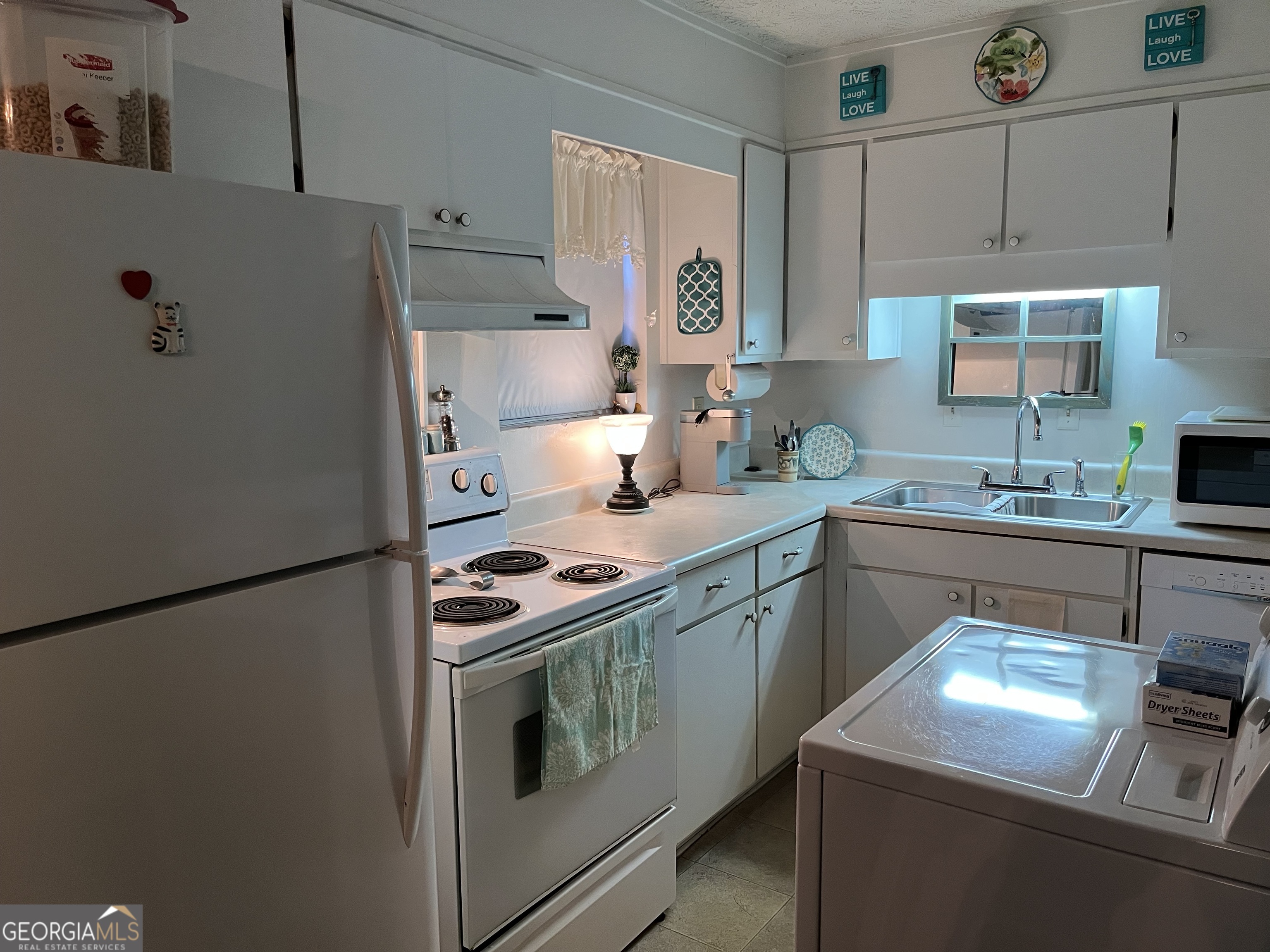 501 Carlton Road, Unit 4C Palmetto, GA 30268 - Photo 5 of 12 a kitchen with stainless steel appliances granite countertop a refrigerator sink stove and white cabinets
