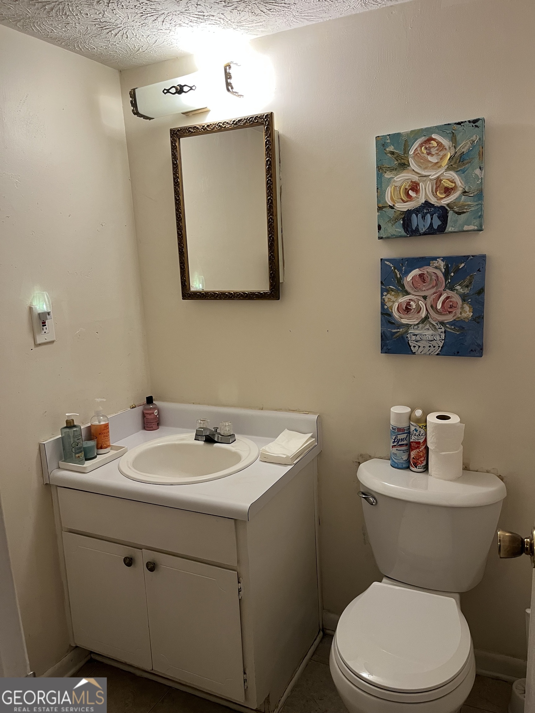 501 Carlton Road, Unit 4C Palmetto, GA 30268 - Photo 7 of 12 a bathroom with a toilet sink and mirror